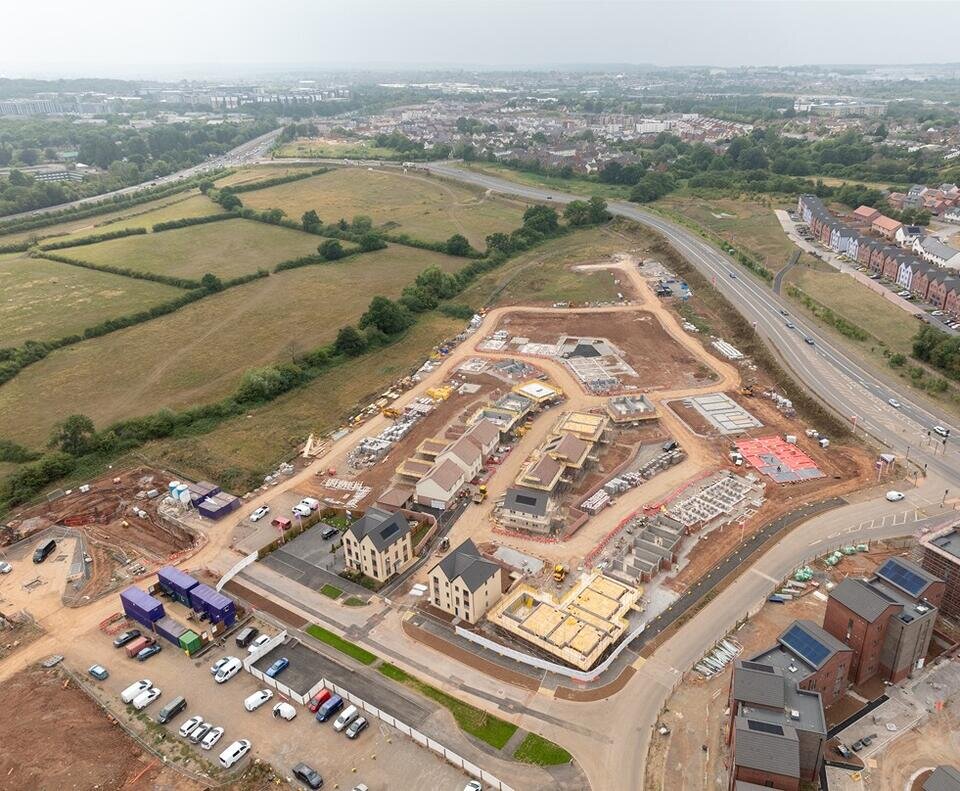 An image taken from a drone. The photo shows a vast plot of land where new homes are being built.
