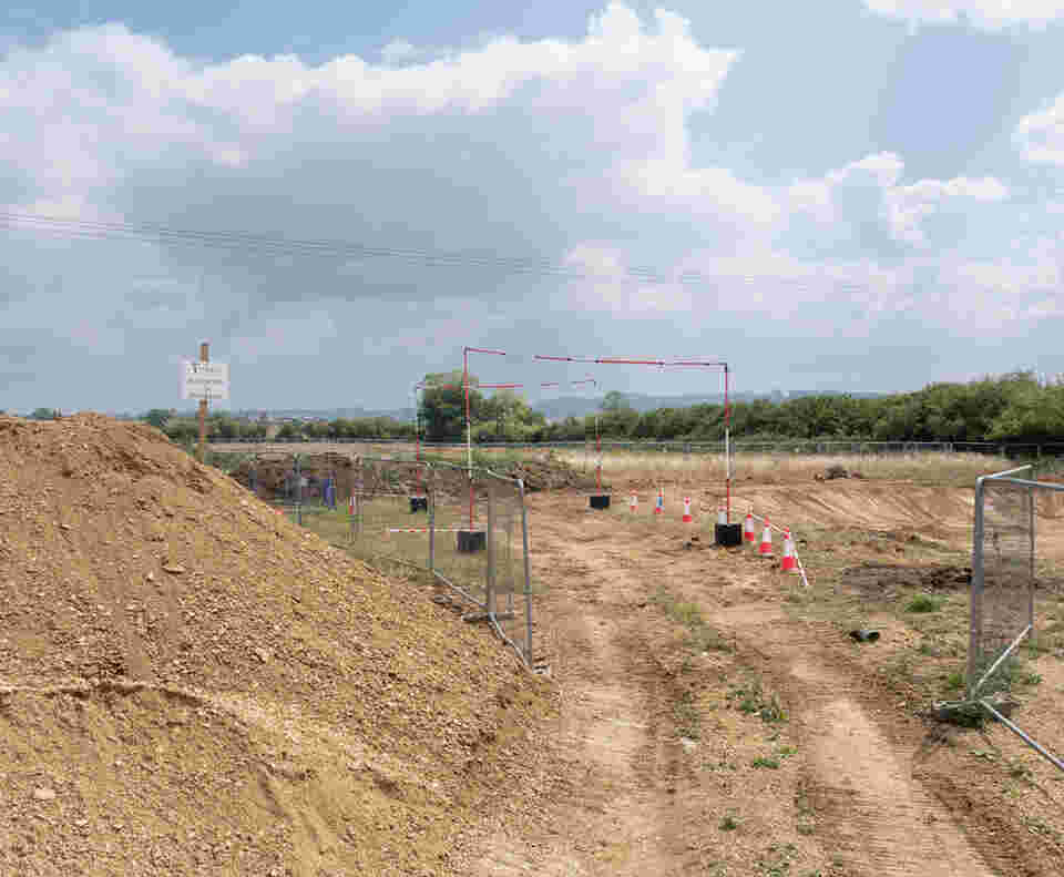 A path made in the earth which diggers have driven through. Haris fencing is either side along with a height restrictions.