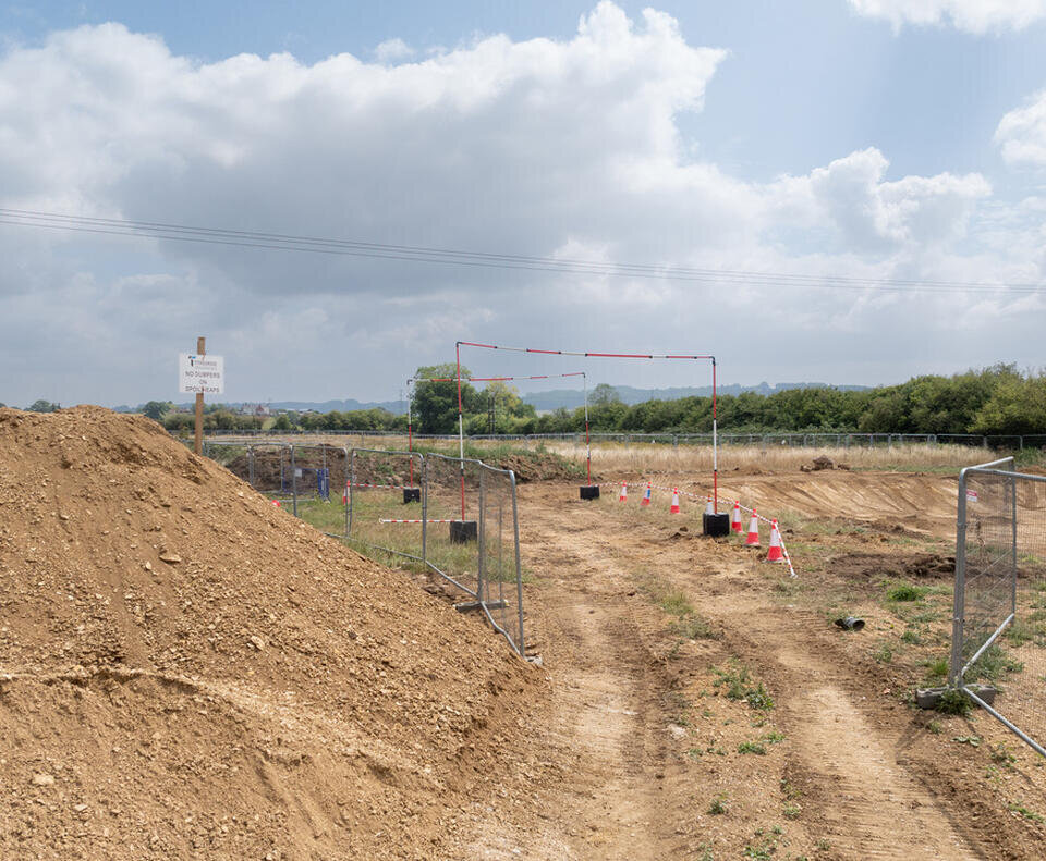 A path made in the earth which diggers have driven through. Haris fencing is either side along with a height restrictions.
